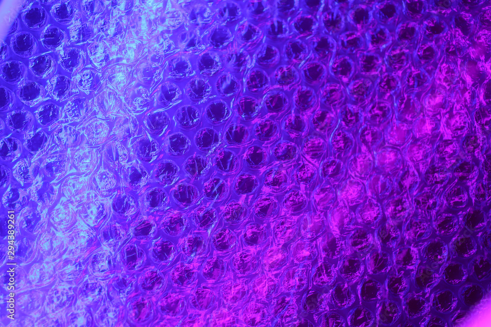 Bubble wrap in neon color. Abstract light blue and pink neon background texture in colorful gradient. Flat lay, copy space, top view. Trendy neon colors background. Bubble wrap in neon color. Abstract light blue and pink neon background texture in colorful gradient. Flat lay, copy space, top view. Trendy neon colors background.