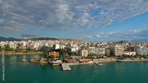 Aerial drone photo of famous seaside town of Halkida or Chalkida with beautiful clouds and deep blue sky featuring old bridge connecting Evia island with mainland Greece