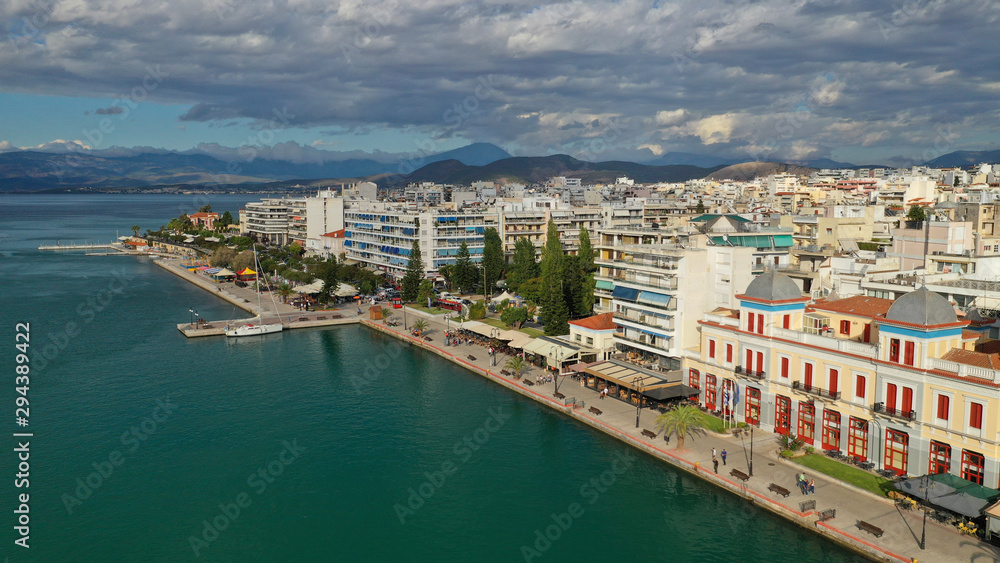 Aerial drone photo of famous seaside town of Halkida or Chalkida with beautiful clouds and deep blue sky featuring old bridge connecting Evia island with mainland Greece