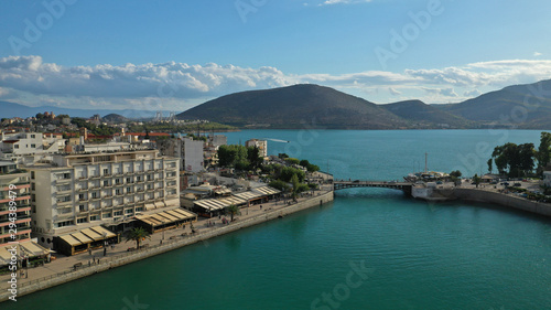 Aerial drone photo of famous seaside town of Halkida or Chalkida with beautiful clouds and deep blue sky featuring old bridge connecting Evia island with mainland Greece