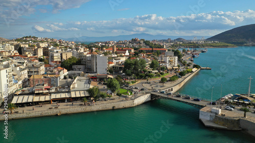 Aerial drone photo of famous seaside town of Halkida or Chalkida with beautiful clouds and deep blue sky featuring old bridge connecting Evia island with mainland Greece