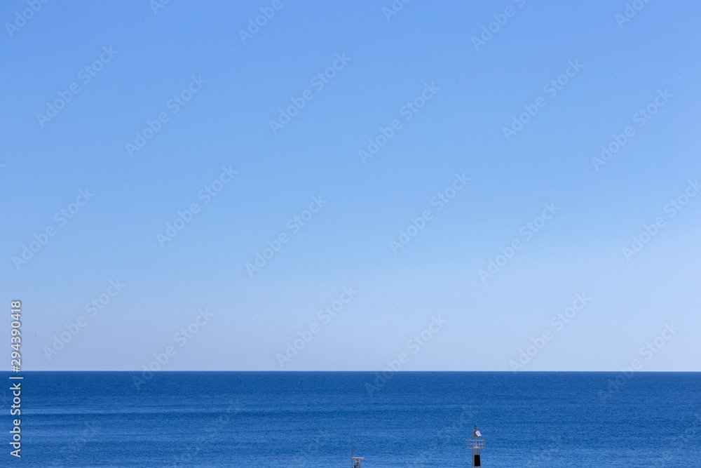 Clear blue sea, horizon and blue sky.