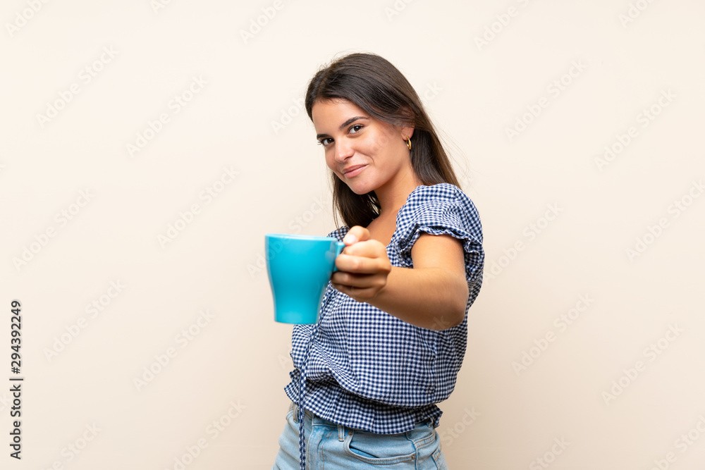 Young girl over isolated background holding hot cup of coffee