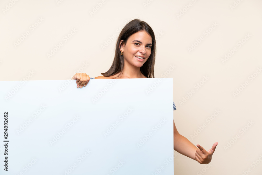 Young girl over isolated background holding an empty white placard for insert a concept Young girl over isolated background holding an empty white placard for insert a concept