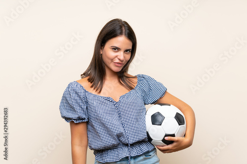 Young girl over isolated background holding a soccer ball © luismolinero
