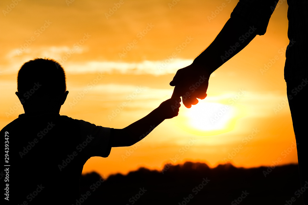 happy dad with a child in the park outdoors silhouette