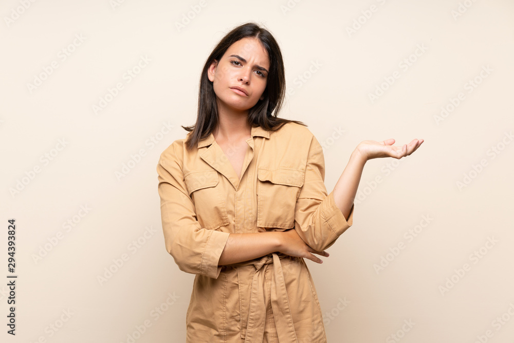 Young girl over isolated background unhappy for not understand something Young girl over isolated background unhappy for not understand something