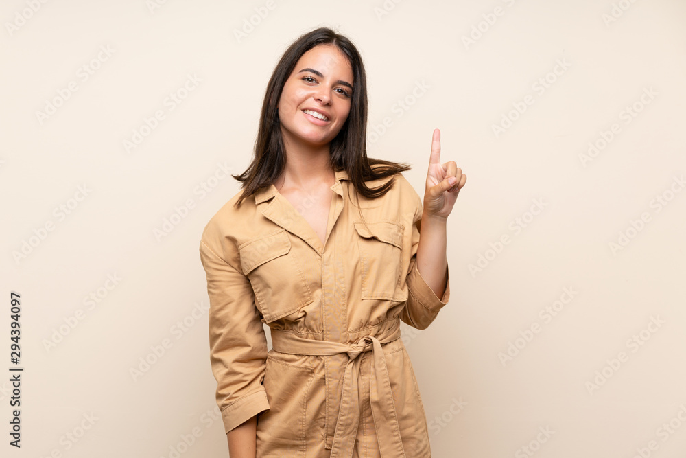 Young girl over isolated background showing and lifting a finger in sign of the best Young girl over isolated background showing and lifting a finger in sign of the best