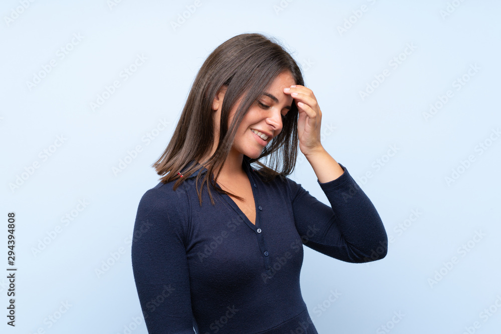 Young girl over isolated blue background laughing Young girl over isolated blue background laughing
