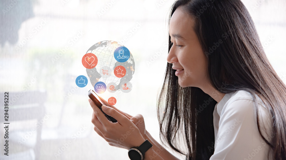 Social media interactions on mobile phone, concept with notification icons of like, message, email, comment and star above smartphone screen, beautiful girl holding device. Social media interactions on mobile phone, concept with notification icons of like, message, email, comment and star above smartphone screen, beautiful girl holding device.