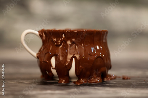 melting chocolate is pouring over cup