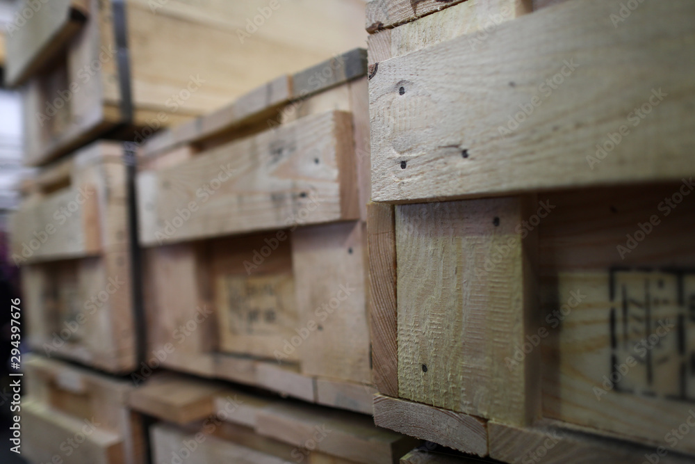 Stack of old wooden packaging boxes standing in column Stack of old wooden packaging boxes standing in column