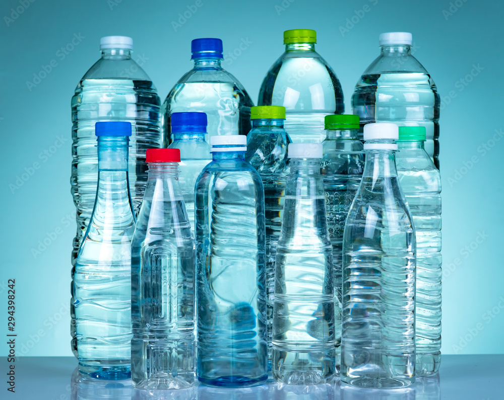 Set of transparent plastic water bottle with blank label. Clear water and natural mineral bottle with white, green, red, and blue cap. Healthy drink. Collection of plastic bottle with full liquid. Set of transparent plastic water bottle with blank label. Clear water and natural mineral bottle with white, green, red, and blue cap. Healthy drink. Collection of plastic bottle with full liquid.