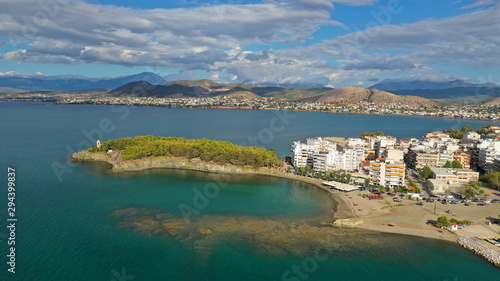 Aerial drone photo of iconic lighthouse built in small islet in famous city of Halkida or Chalkida with clear water seascape and beautiful sky - clouds, Evia island, Greece