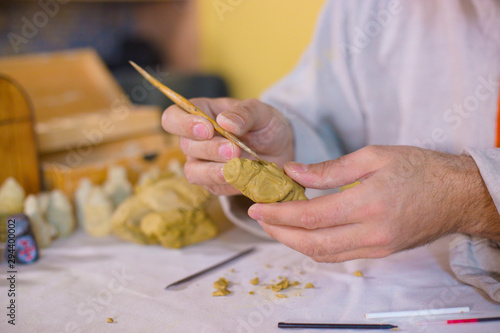 Potter making clay figure for board game