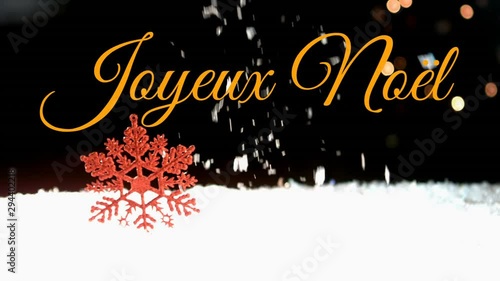 Joyeux NoÃ«l written over snow falling photo