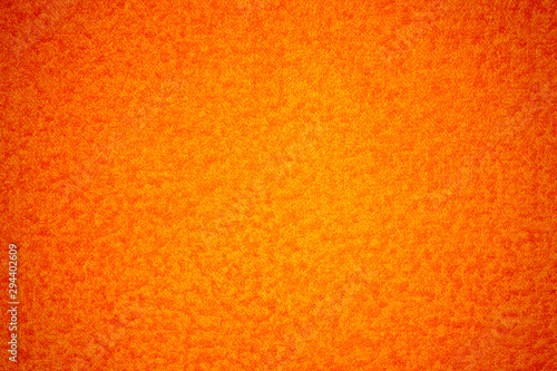 Texture. Bright orange color with light, yellow, rounded particles.