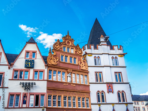 Main Market Square buildings partial exterior view with the Red House, Rote Haus from 1684 and the 15th-century Gothic building of the Steipe in Trier, Germany photo