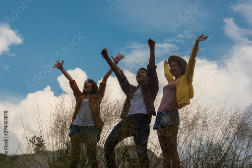 happy group of young people on cliff of mountain