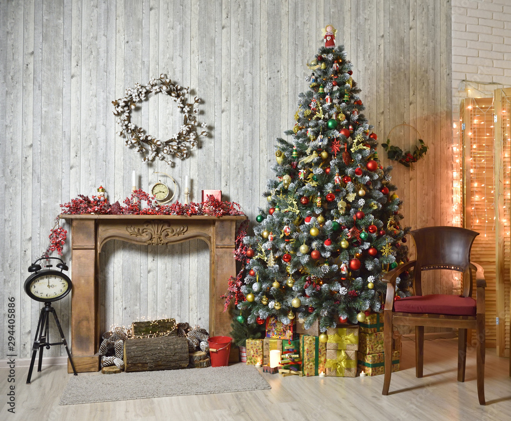 Beautiful brown Christmas interior with Christmas tree, wood fireplace and armchair