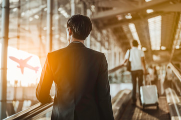 Businessman moving to terminal gate for check in boarding with luggage at the airport to business trip.