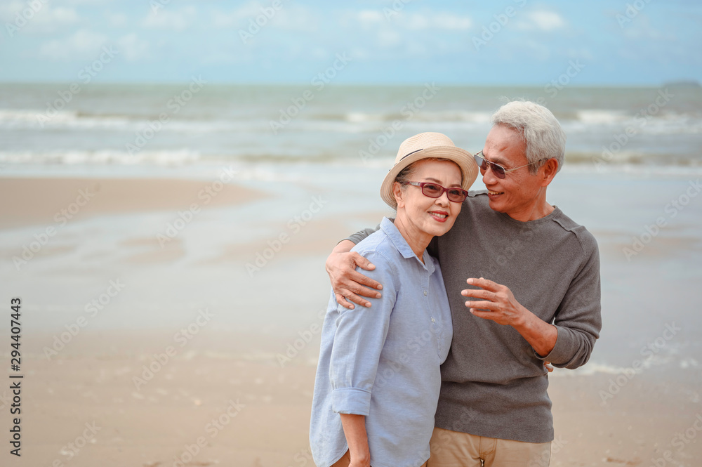 Senior couples embrace the sunrise beach, plan life insurance with the concept of happy retirement. Senior couples embrace the sunrise beach, plan life insurance with the concept of happy retirement.