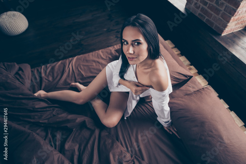Above high angle view of her she nice-looking attractive lovely lovable pretty nude girl sitting on bed bare foot teasing undressing at industrial brick wood loft modern interior style flat house photo
