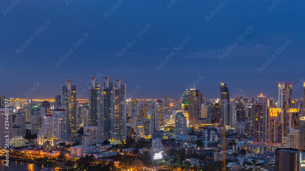 Panorama of landscape with sunset over the building and blue sky at bangkok ,Thailand. View of the tall building in capital with twilight Panorama of landscape with sunset over the building and blue sky at bangkok ,Thailand. View of the tall building in capital with twilight