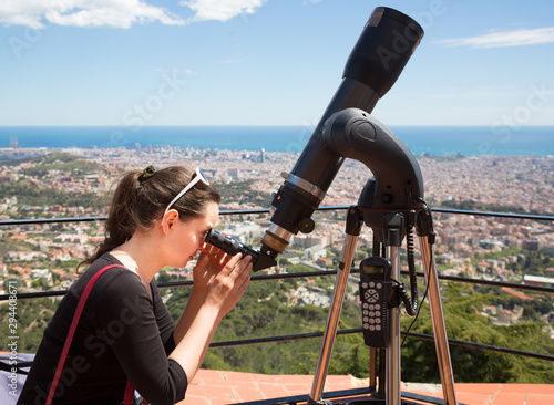 woman  looking in telescope photo