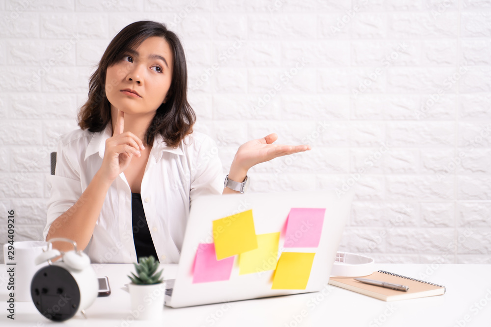 Portrait of a confused woman sitting at office Portrait of a confused woman sitting at office
