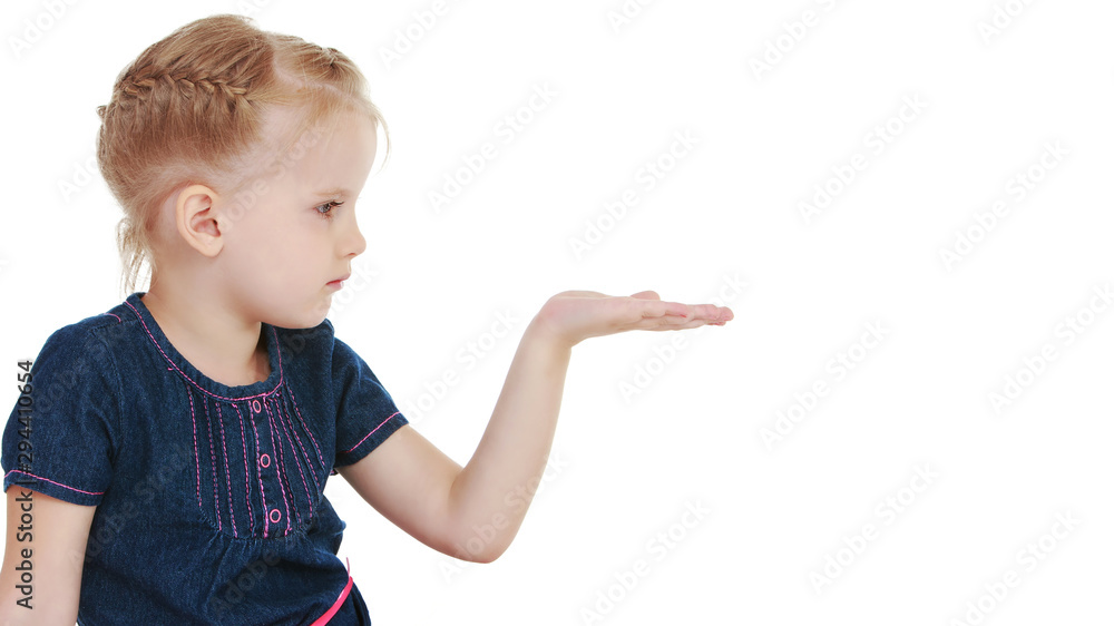 Little girl is showing a finger.The concept of advertising goods Little girl is showing a finger.The concept of advertising goods