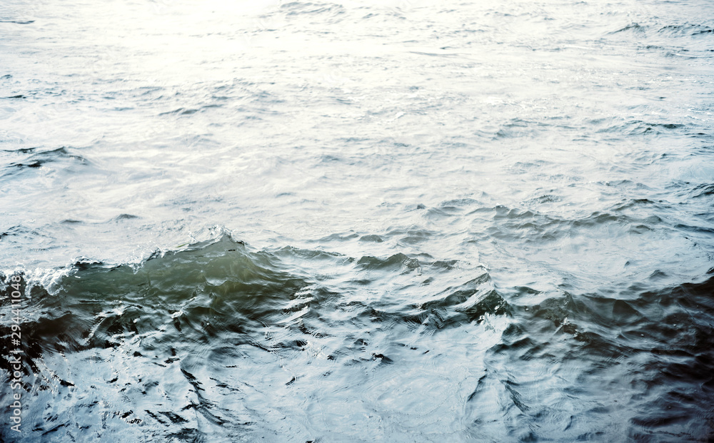 Fototapeta premium Water surface with ripples and sunlight reflections