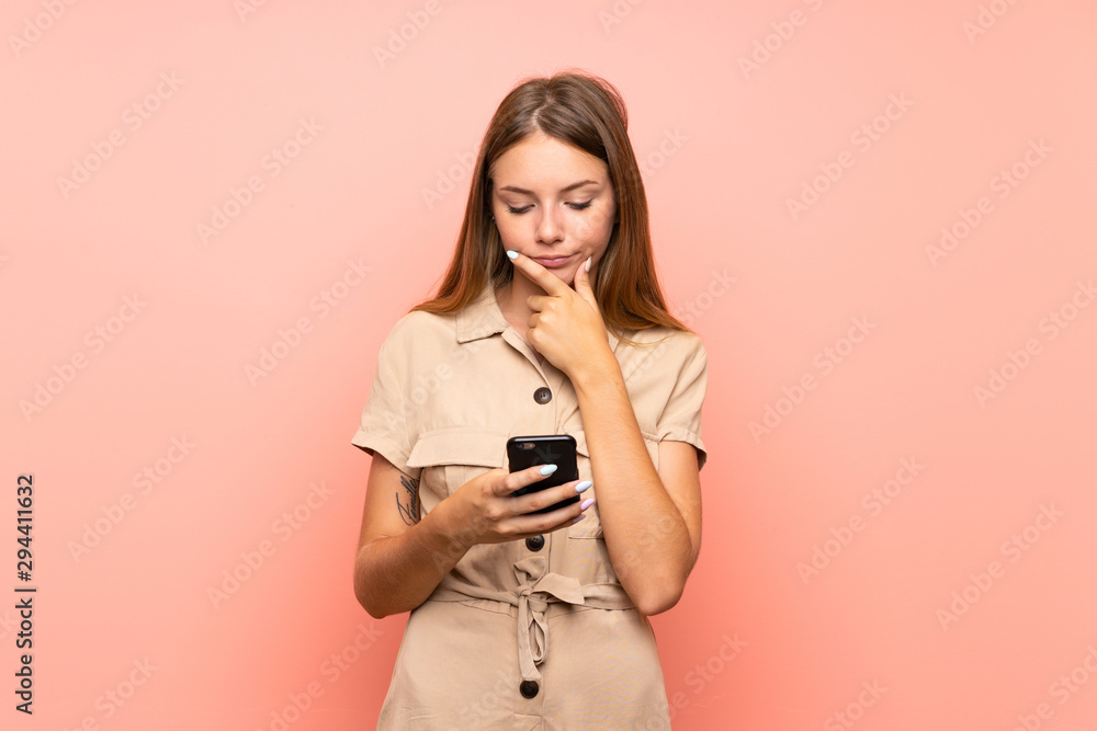 Lithuanian blonde girl over isolated pink background thinking and sending a message Lithuanian blonde girl over isolated pink background thinking and sending a message