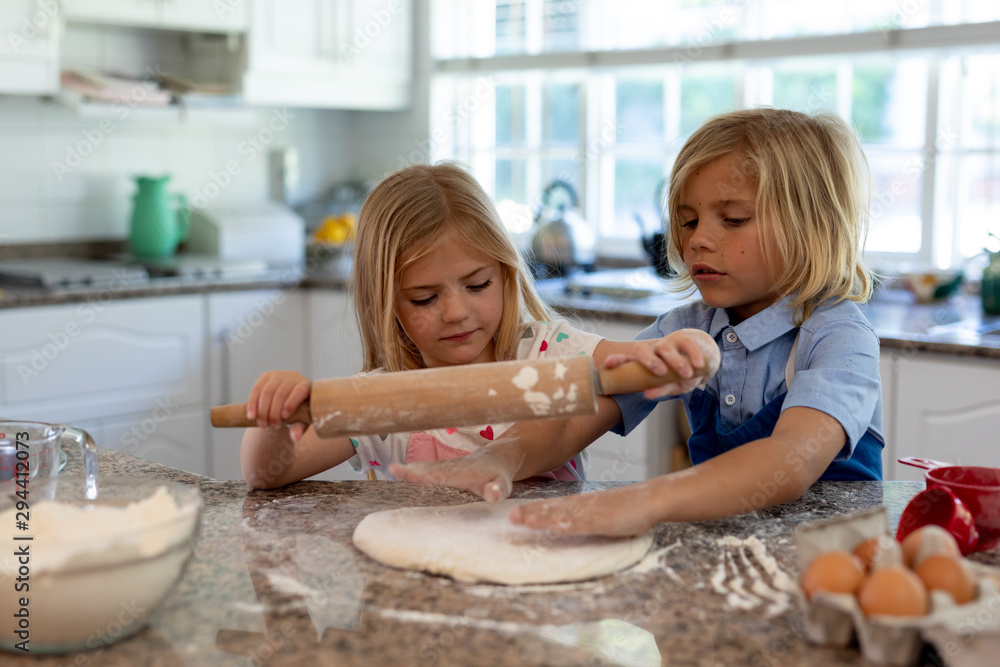 Brother and sister making Christmas cookies at home Brother and sister making Christmas cookies at home
