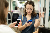 Woman using phone in public transport