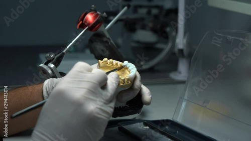 the process of processing dental crowns. laboratory. close-up