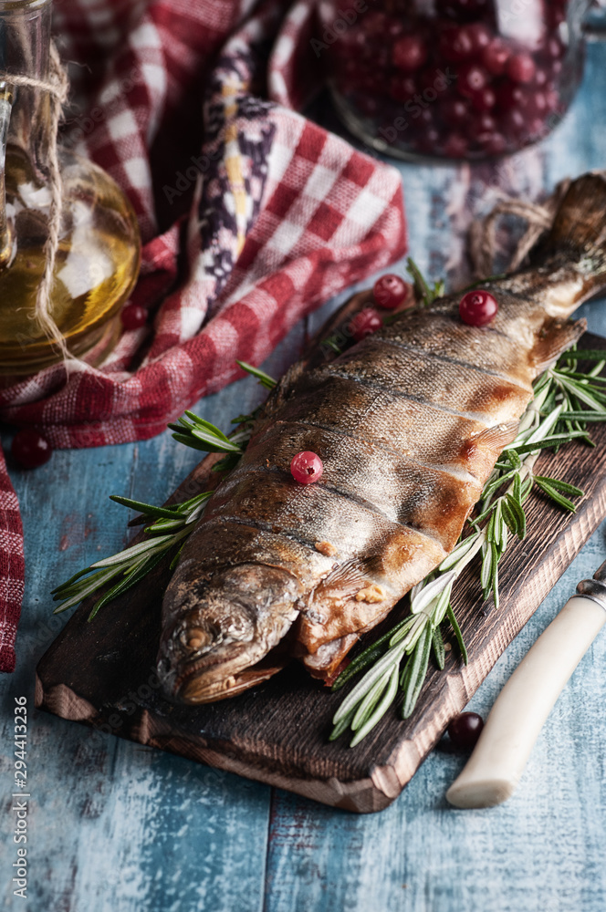 hot smoked fish, different options. on wooden board and wooden table hot smoked fish, different options. on wooden board and wooden table