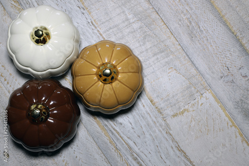 Glass Pumpkins against distressed wooden surface backbround