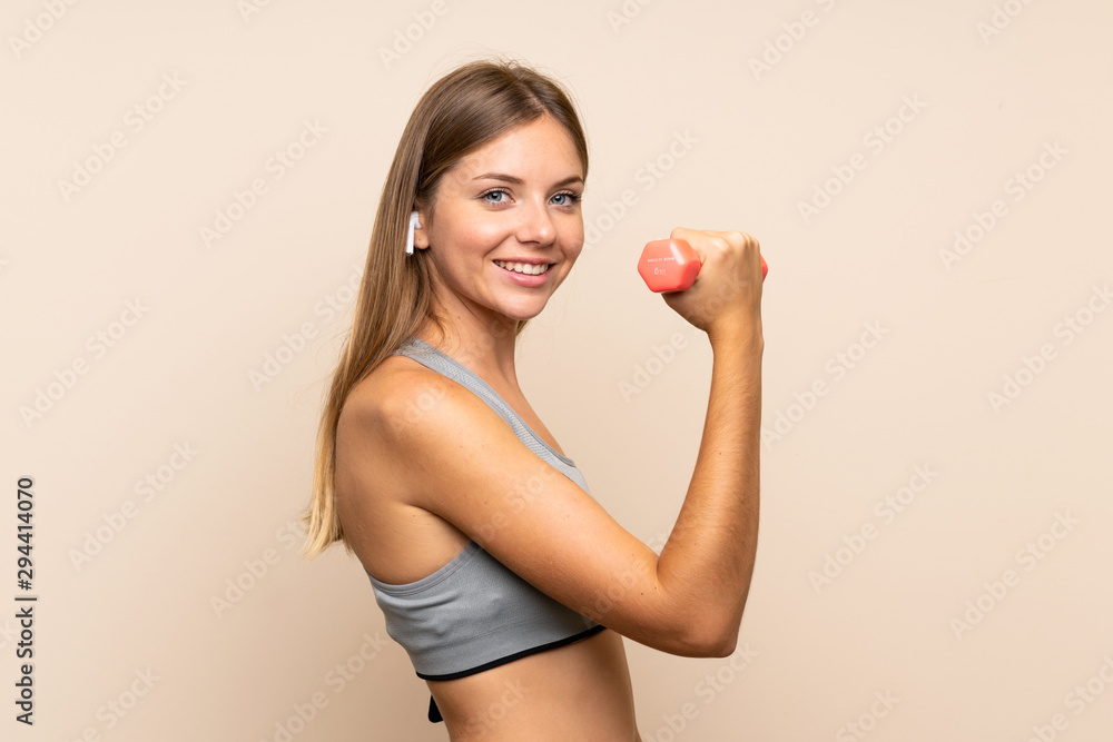 Young blonde sport girl over isolated background making weightlifting Young blonde sport girl over isolated background making weightlifting
