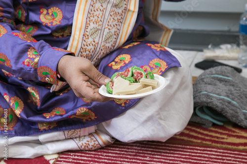Hinduism ceremony hands with plate and sweet treats