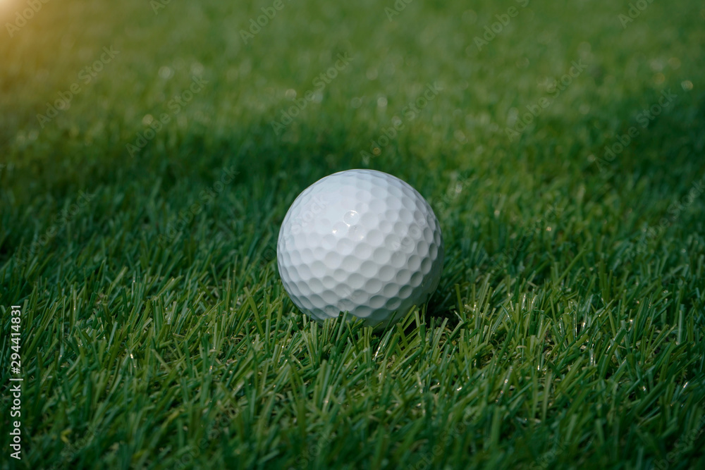 Golf ball on green in beautiful golf course at sunset background. Golf ball on green in beautiful golf course at sunset background.
