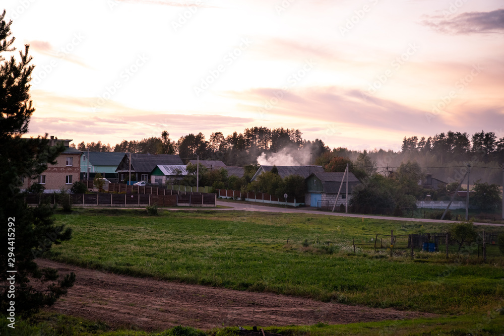 Natural Belarus village in light of sunset Natural Belarus village in light of sunset