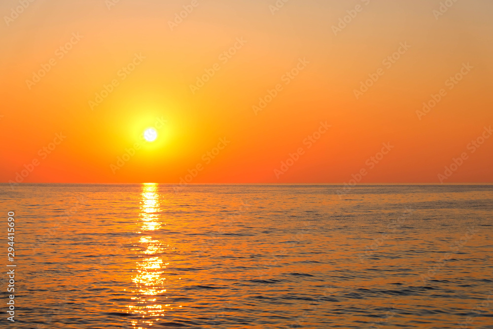 Beautiful romantic sunset view of the sea with sun reflection on water