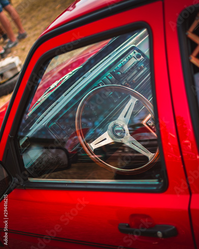 Sports steering wheel with a wooden texture on a red european car