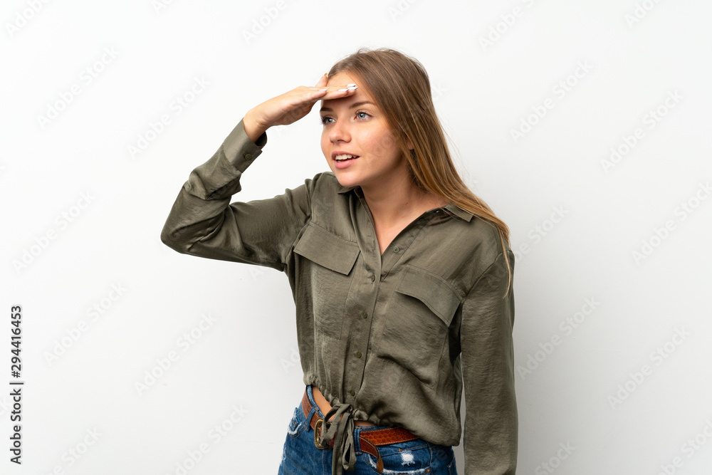 Lithuanian blonde girl over isolated white background looking far away with hand to look something Lithuanian blonde girl over isolated white background looking far away with hand to look something