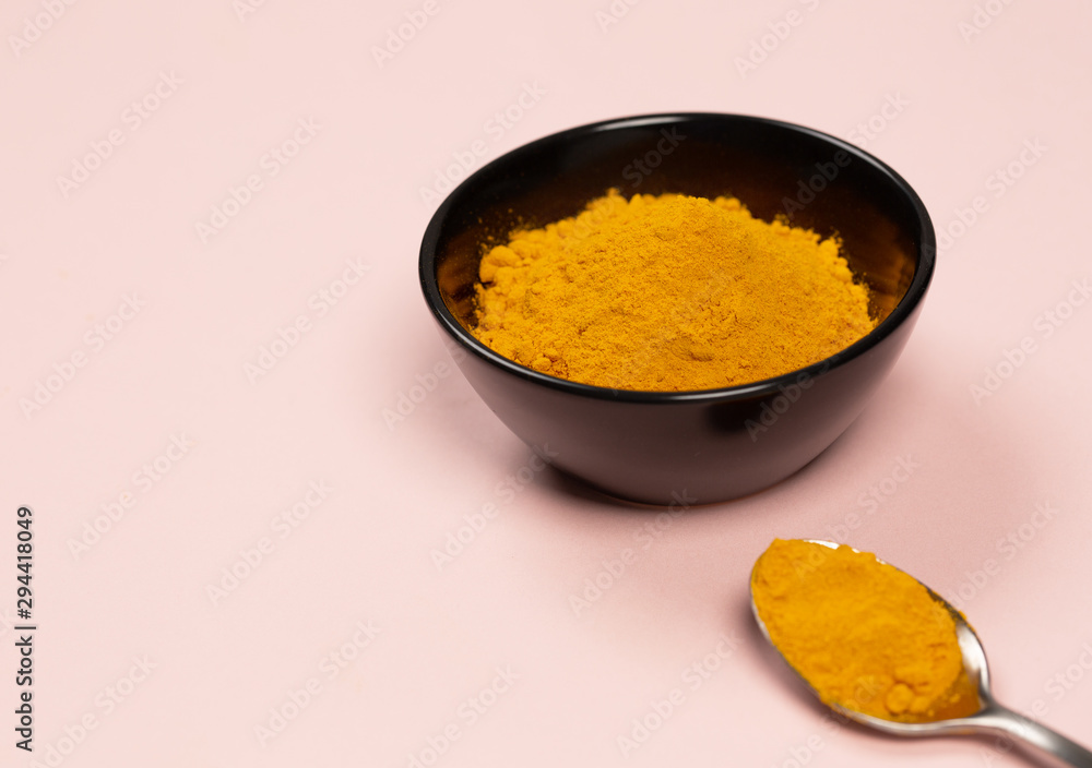 Turmeric powder close up on a coralcooking table Turmeric powder close up on a coralcooking table