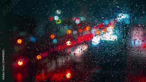 window glass with rain drop and street traffic