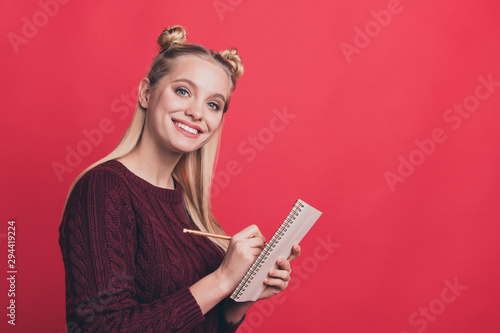 Side profile close up photo portrait of pretty nice lovely dreamy confident girl making notes into paper copy book isolated pastel color background