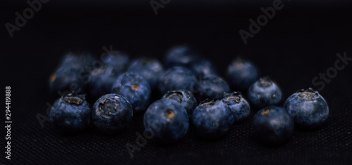 Some fresh and healthy blueberries on black background