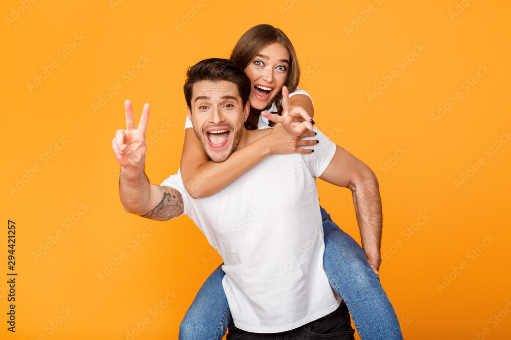 Freedom and fun. Playful couple gesturing peace signs Freedom and fun. Playful couple gesturing peace signs